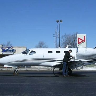 Fueling jet airplane on ramp in front of Solo Aviation.