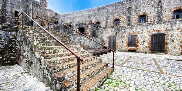Legendary Citadelle Henri Christophe the largest stone fortress courtyard with stairs and cannons.