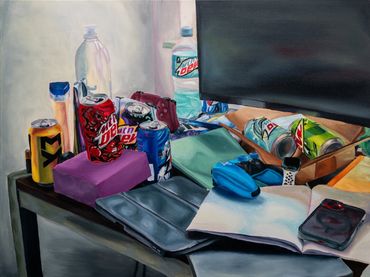 A cluttered desk with drinks, papers, and electronics.