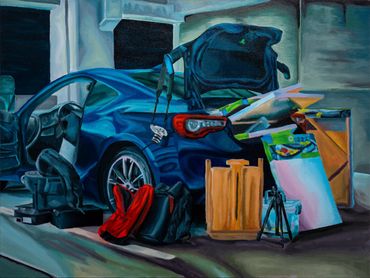 A blue car with its doors and trunk open, surrounded by various bags and boxes.