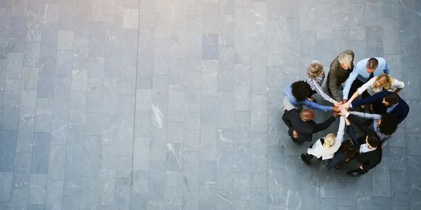 overhead picture of structural engineers in a team huddle. discussing residential design. 