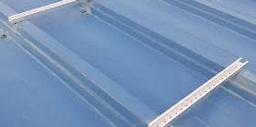 Clear acrylic shelves with metal brackets on a blue surface.