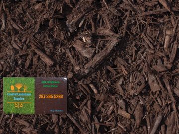 Brown Mulch with Coastal Landscape Supplies business card in the corner.