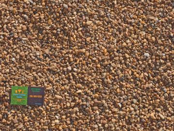 Pea Gravel with Coastal Landscape Supplies business card in the corner.