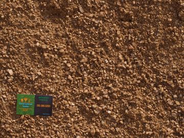 Decomposed Granite with Coastal Landscape Supplies business card in the corner.