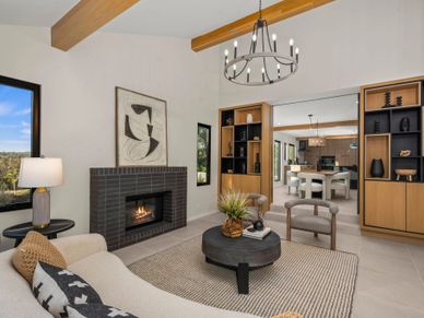 Modern living room with fireplace and wooden beams.