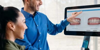 Dentist showcasing invisalign scan of patients teeth.