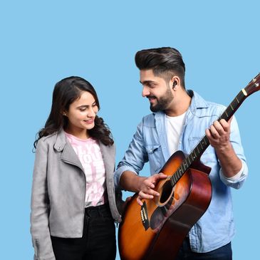 Teacher engaging with students raising their hands in class.