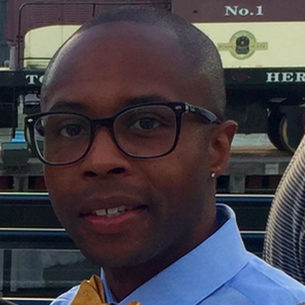 Julius McGee, CEO Nerd Alert. Man with blue collared shirt and black glasses. Headshot.