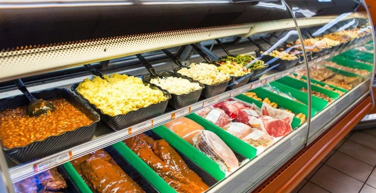 A Frozen Freezer Counter With Trays of Food