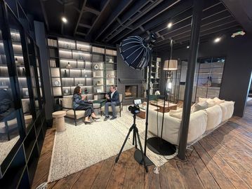 Two people talking in a modern studio setup.