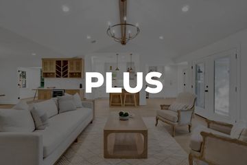 Modern living room with neutral tones and minimalist furniture.