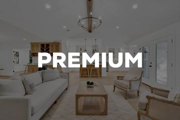 Bright and spacious living room with modern furniture and wooden accents.