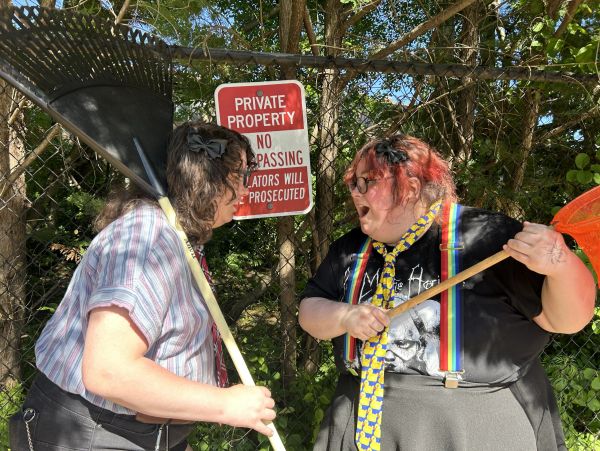 Two people with rakes confront each other near a private property sign.