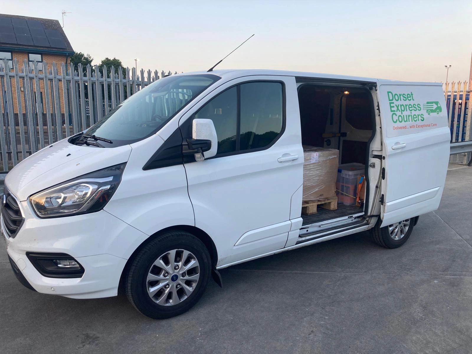 Dorset Express Couriers van outside a factory, preparing to complete a crucial same day delivery.