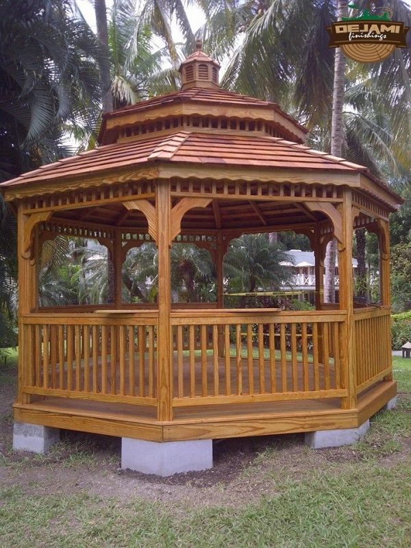 Wooden gazebo in a garden setting.
