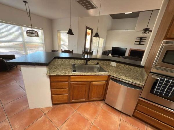 Modern kitchen with granite countertops and stainless steel appliances.