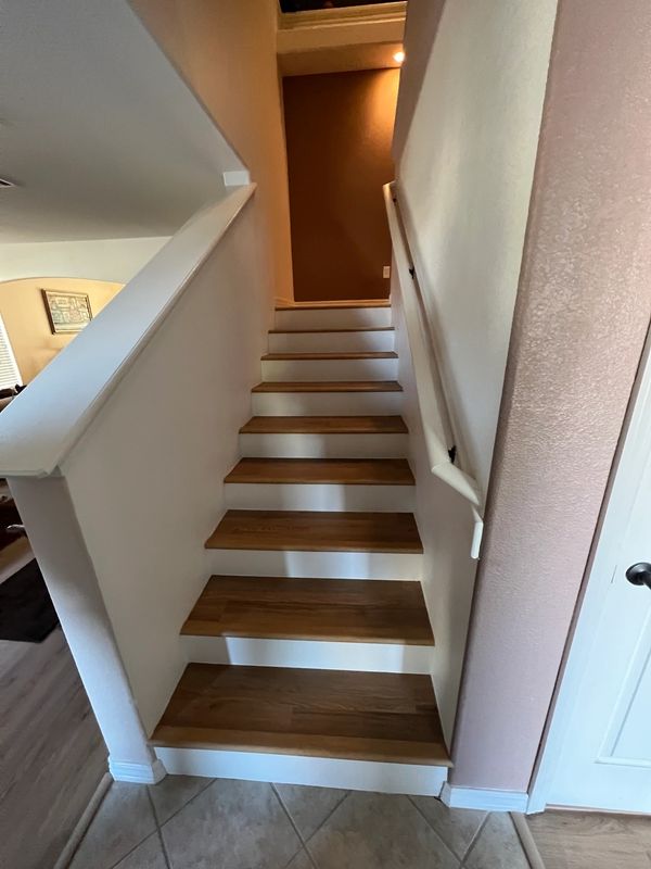 Narrow staircase with wooden steps inside a home.
