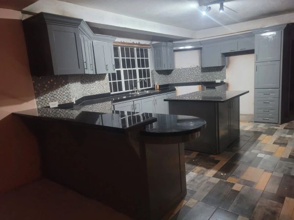 Modern kitchen with gray cabinets and a central island.