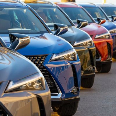 A lineup of colorful luxury SUVs parked closely together.