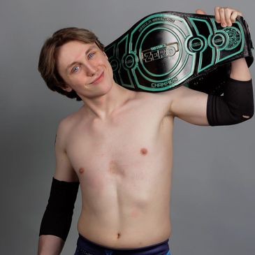 NEBULA Wrestling District Zero champion Glitch holding the championship belt