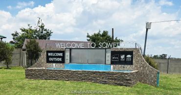 Welcome sign for Soweto with a small pool.