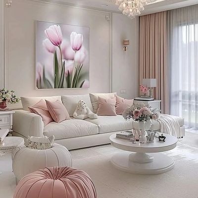 Elegant living room with soft pink and white decor, featuring floral artwork and plush seating.