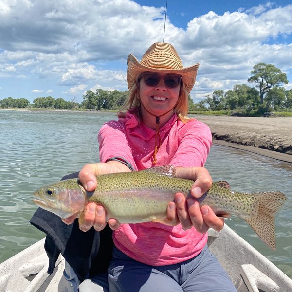 Woman holding a rainbow trout o the Yellowstone River Near Bozeman, Montana