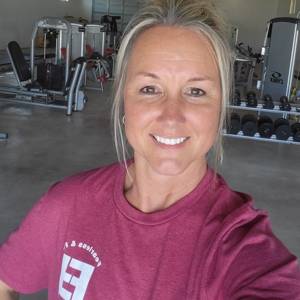 Woman smiling in a gym setting.