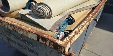 Skip bin filled with Carpet