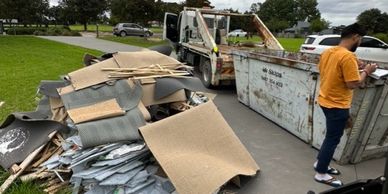 Team member loading a skip bin for a customer on the Central Coast