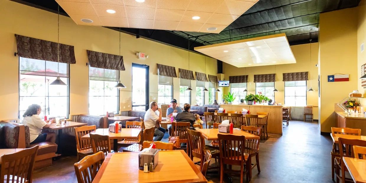 A picture of the friends eating in the pecan restaurant