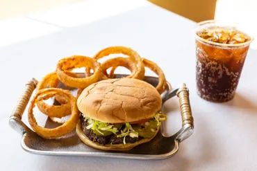 A Picture of the burger and onion rings served on a plate