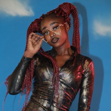 Young ebony model posing for blue backrop