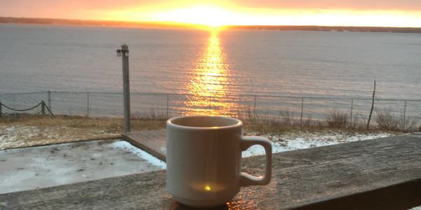 Coffee cup on a balcony overlooking the ocean in Head of Jeddore