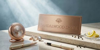 Elegant desk setup with Sandalwood Shore nameplate and rose gold accessories.