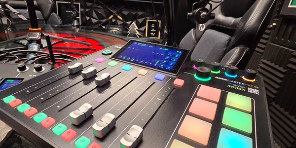 Podcast studio with Rodecaster Pro II and comfortable chairs.