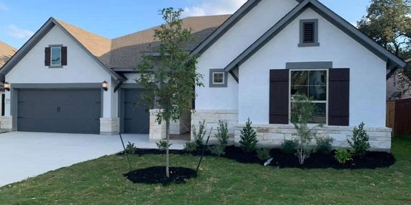 Modern single-story house with white exterior and front yard landscaping.