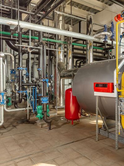 Industrial boiler room with pipes and valves.