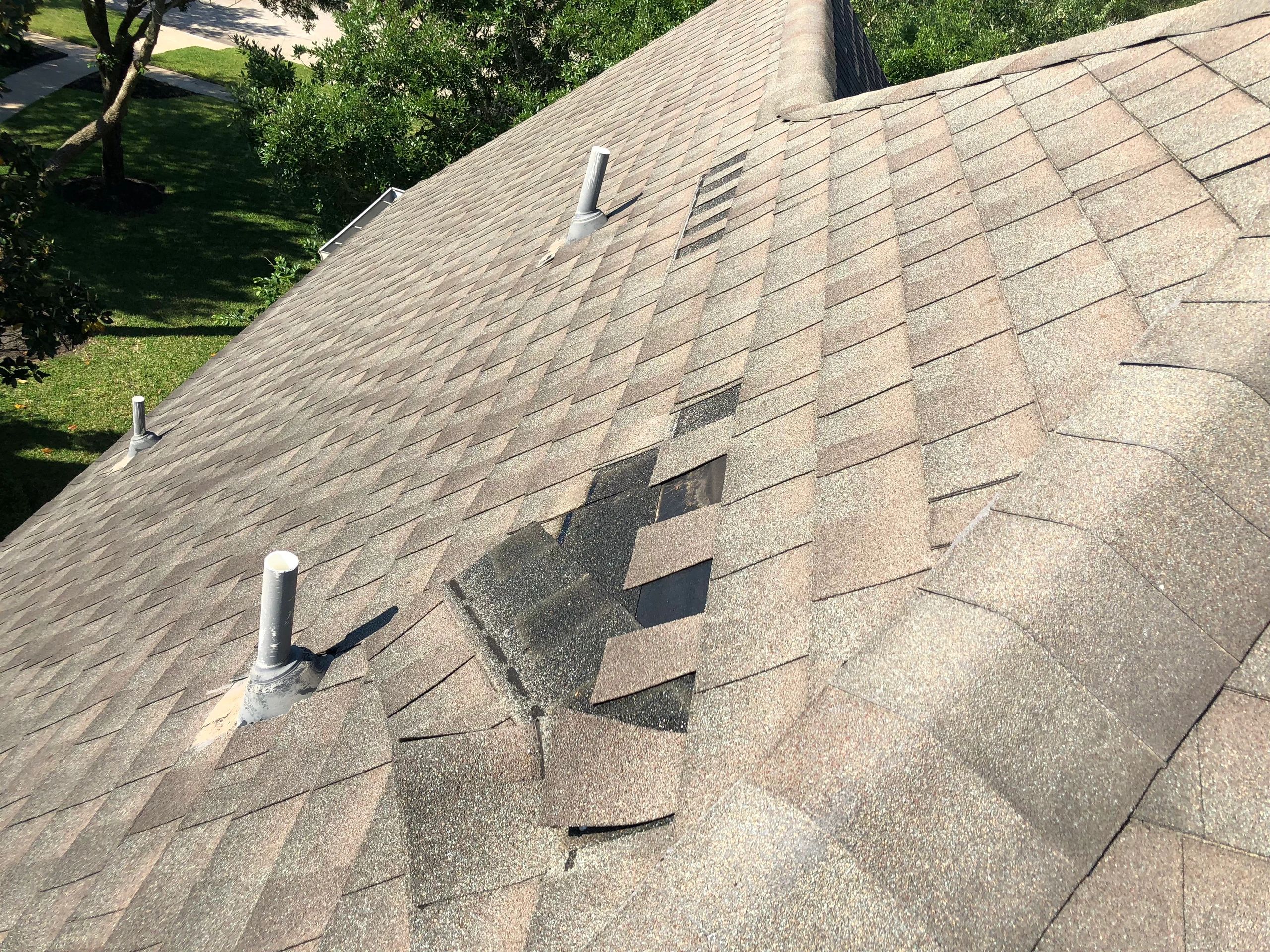 Wind damaged shingles Keystone Contracting Group helps with insurance claims