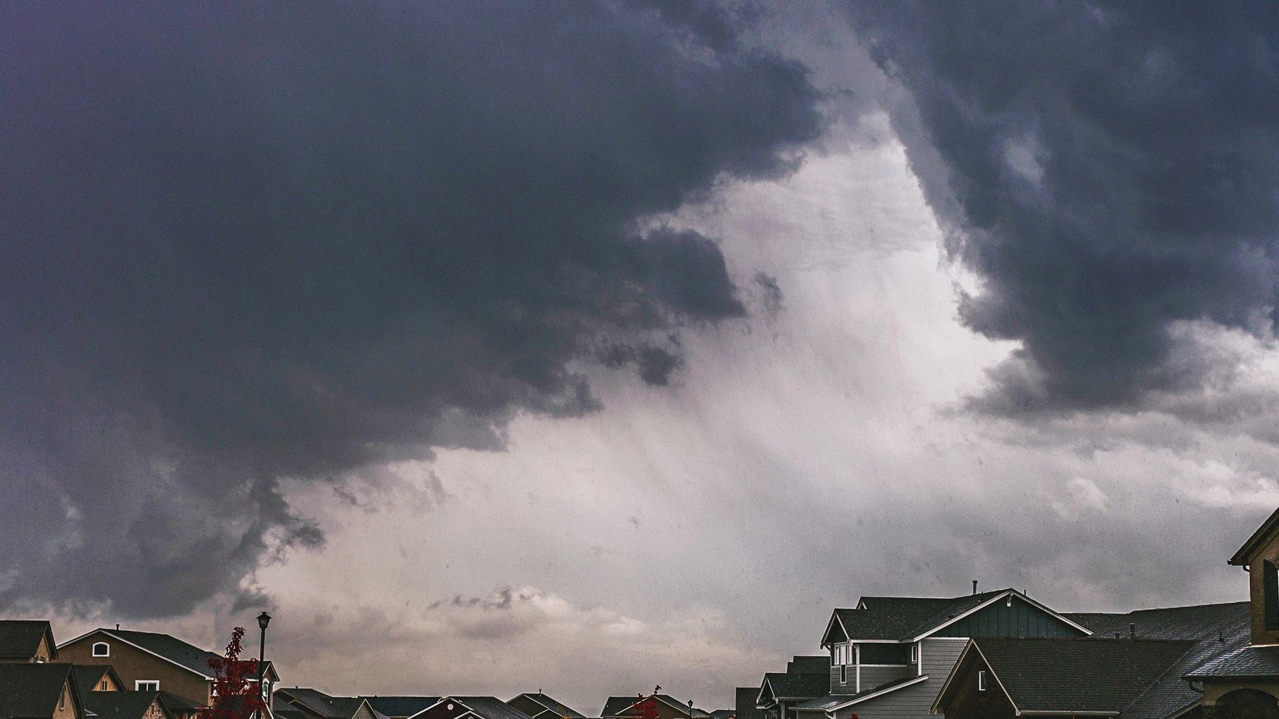 Storm over a residential shingle  roof neighborhood