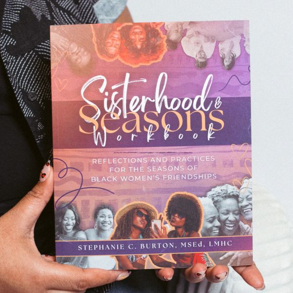 Person holding the Sisterhood &amp; Seasons Workbook by Stephanie C. Burton.