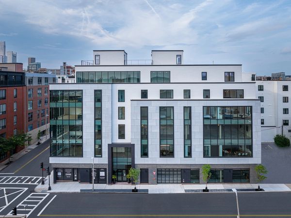 Modern multi-story building with large windows.
