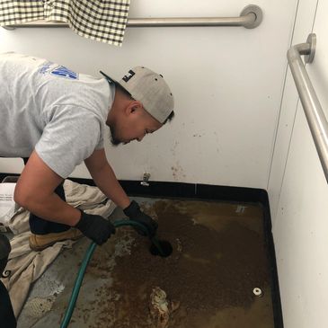 clearing a clogged sewer drain.