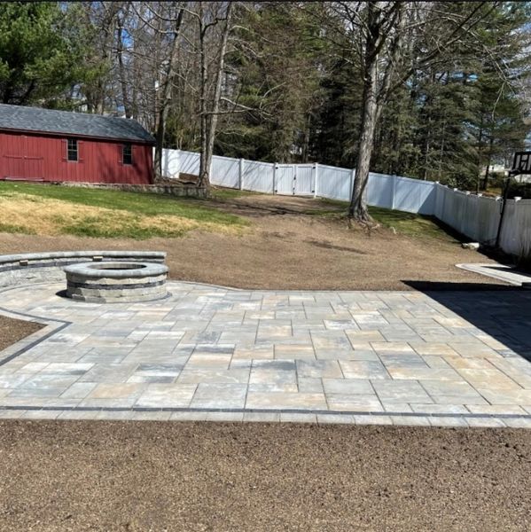 New paver patio with sitting wall and fire pit