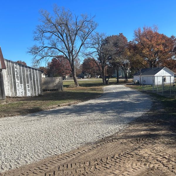 A Gravel Road Leading to a Barn