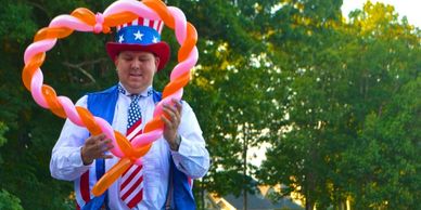 The Amazing Ziggy Twisitng Balloons and Stilt Walking for a 4th of July Celebration in Stockbridge, 