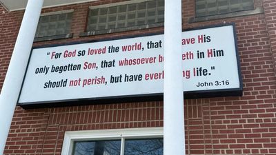 A Bible verse from John 3:16 displayed on a church sign.