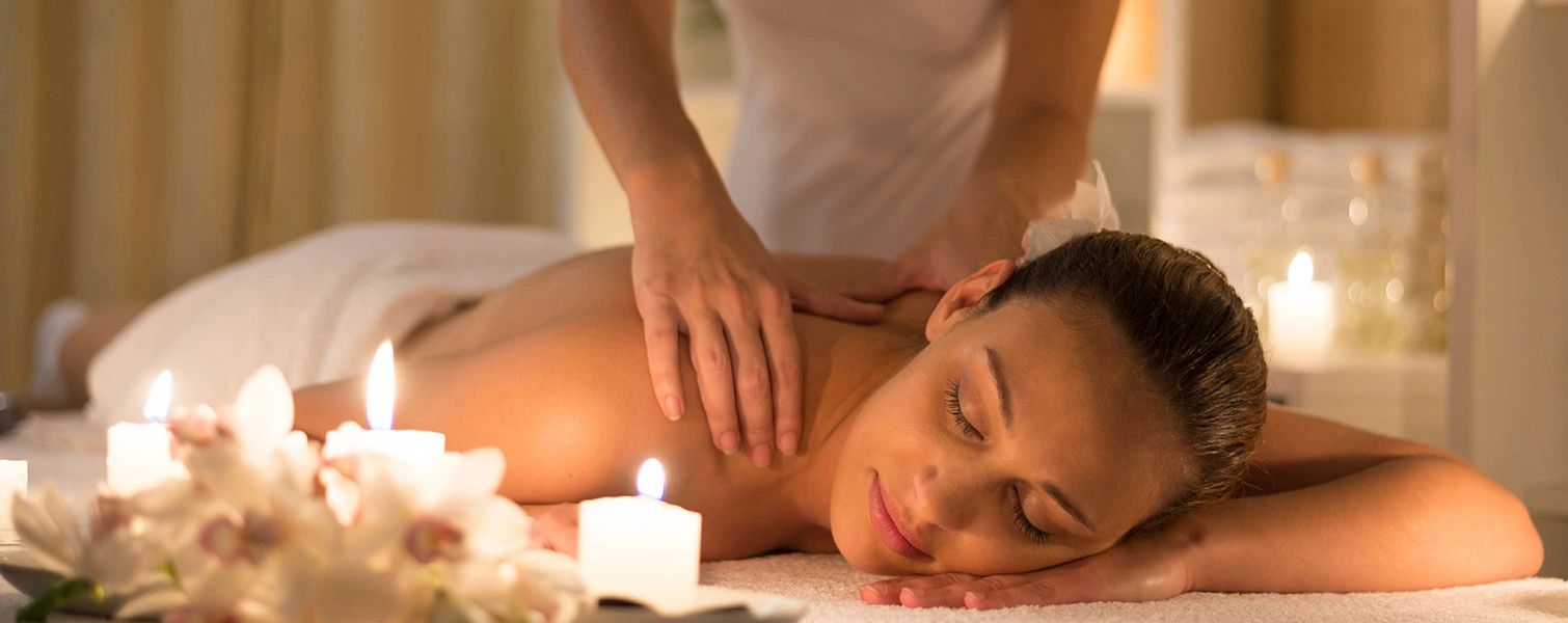 Woman enjoying a relaxing back massage in a peaceful spa setting.