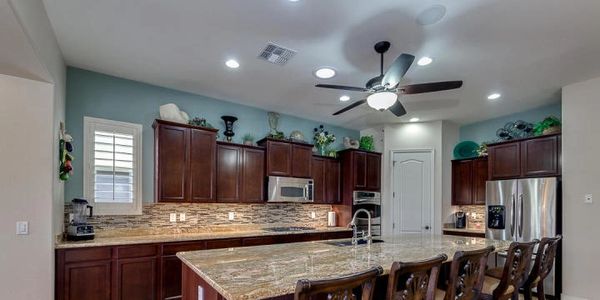 Large kitchen island with custom upgraded cabinets and granite counter tops.